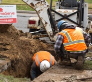 Workers fixing sewer line underground