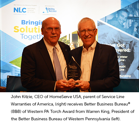 John Kitzie and Warren King holding Torch Award